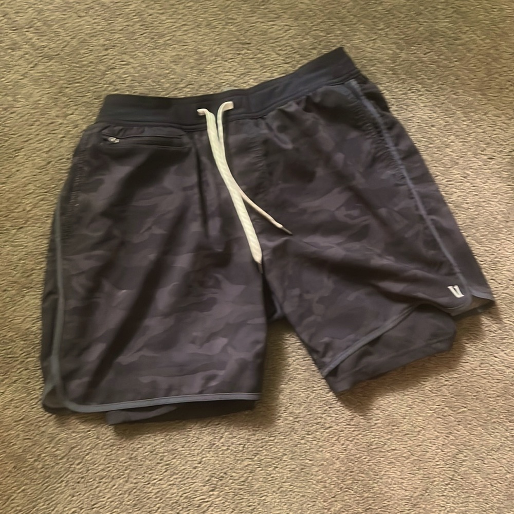 Pair of Vuori Black camo shorts with liner and several pockets.